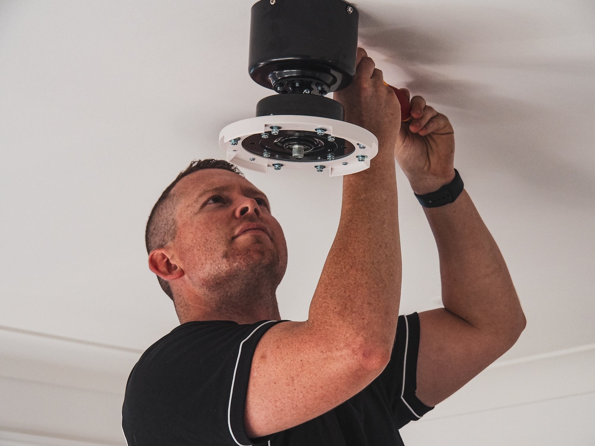 Ben Stokes installing a ceiling fan — licensed Newcastle electrician on the tools